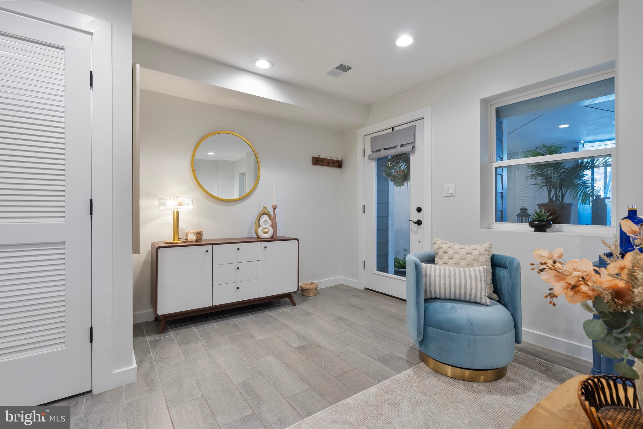 210 Varnum Street Northwest, Unit 1 Washington, DC 20011 - Photo 8 of 22 a living room with furniture a mirror and a window