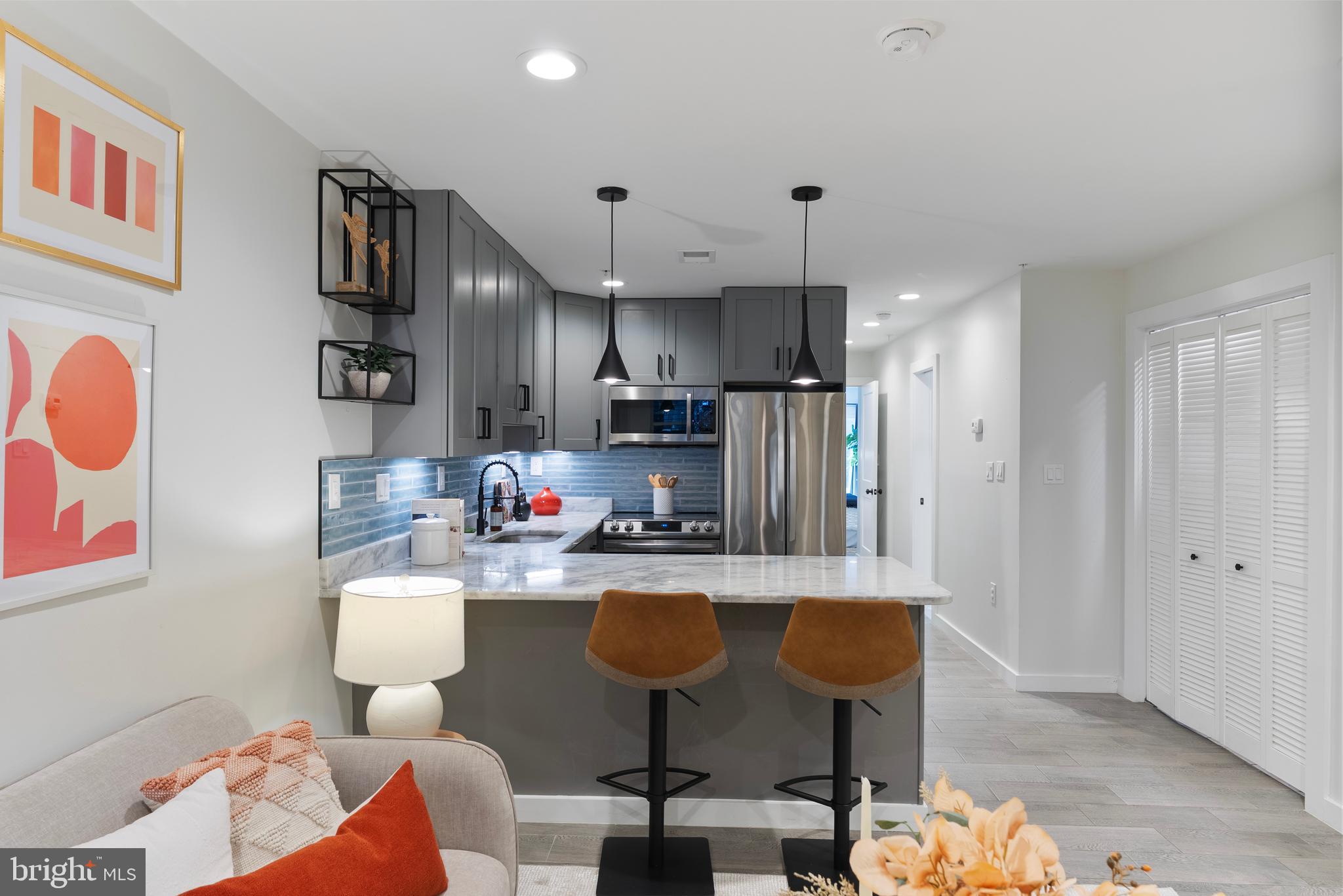 210 Varnum Street Northwest, Unit 1 Washington, DC 20011 - Photo 9 of 22 a kitchen with kitchen island stainless steel appliances a dining table and chairs