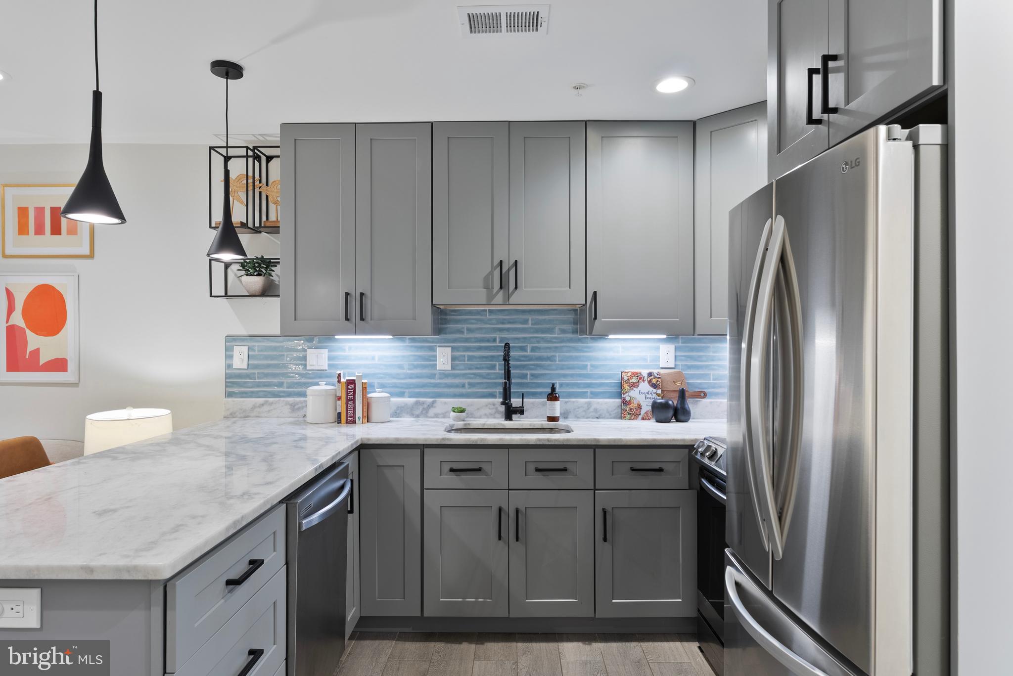 210 Varnum Street Northwest, Unit 1 Washington, DC 20011 - Photo 10 of 22 a kitchen with stainless steel appliances granite countertop a refrigerator sink and cabinets