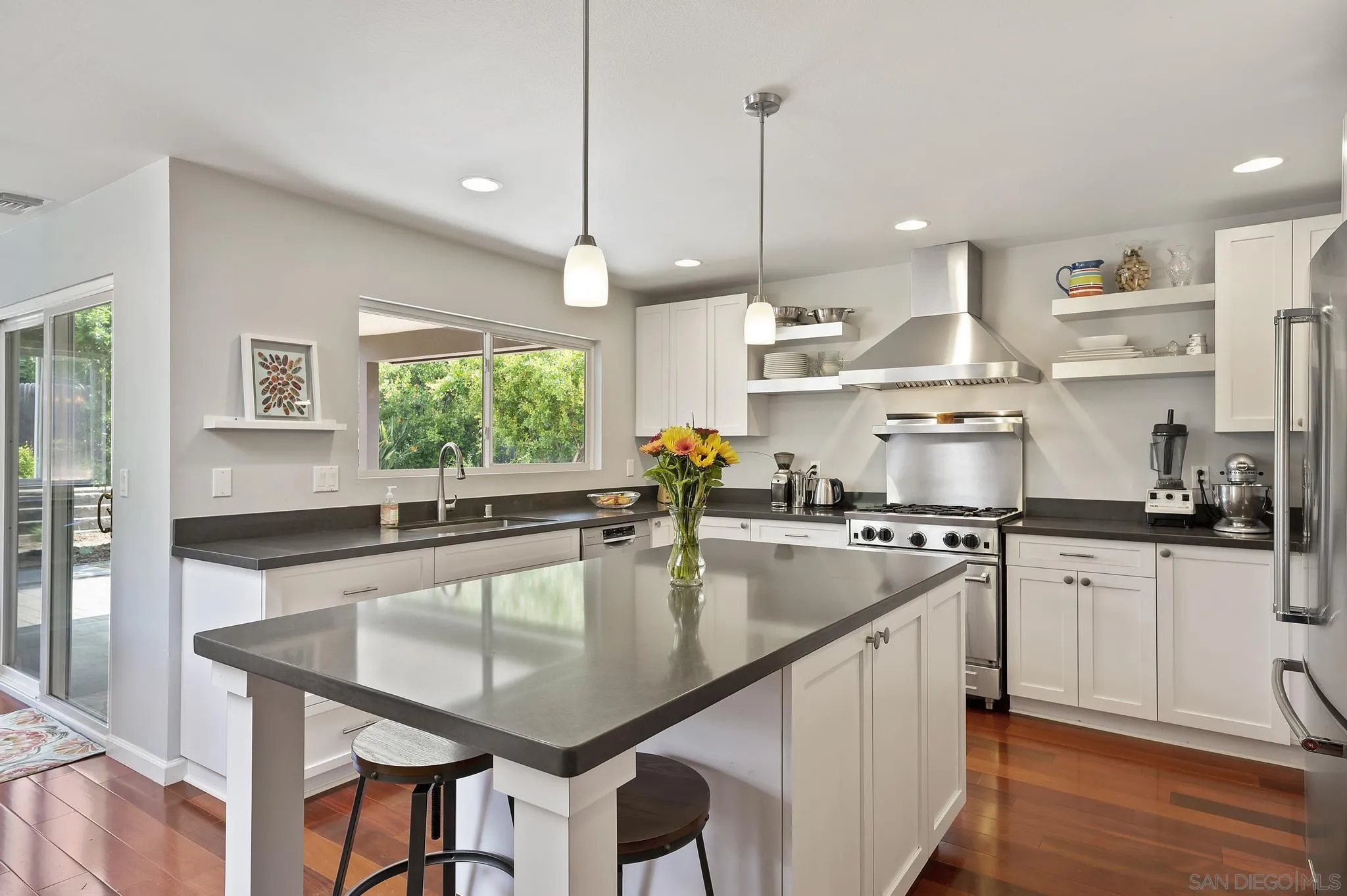 236 Rancho Santa Fe Road Encinitas, CA 92024 - Photo 8 of 32 a large kitchen with kitchen island a large window a sink and stainless steel appliances