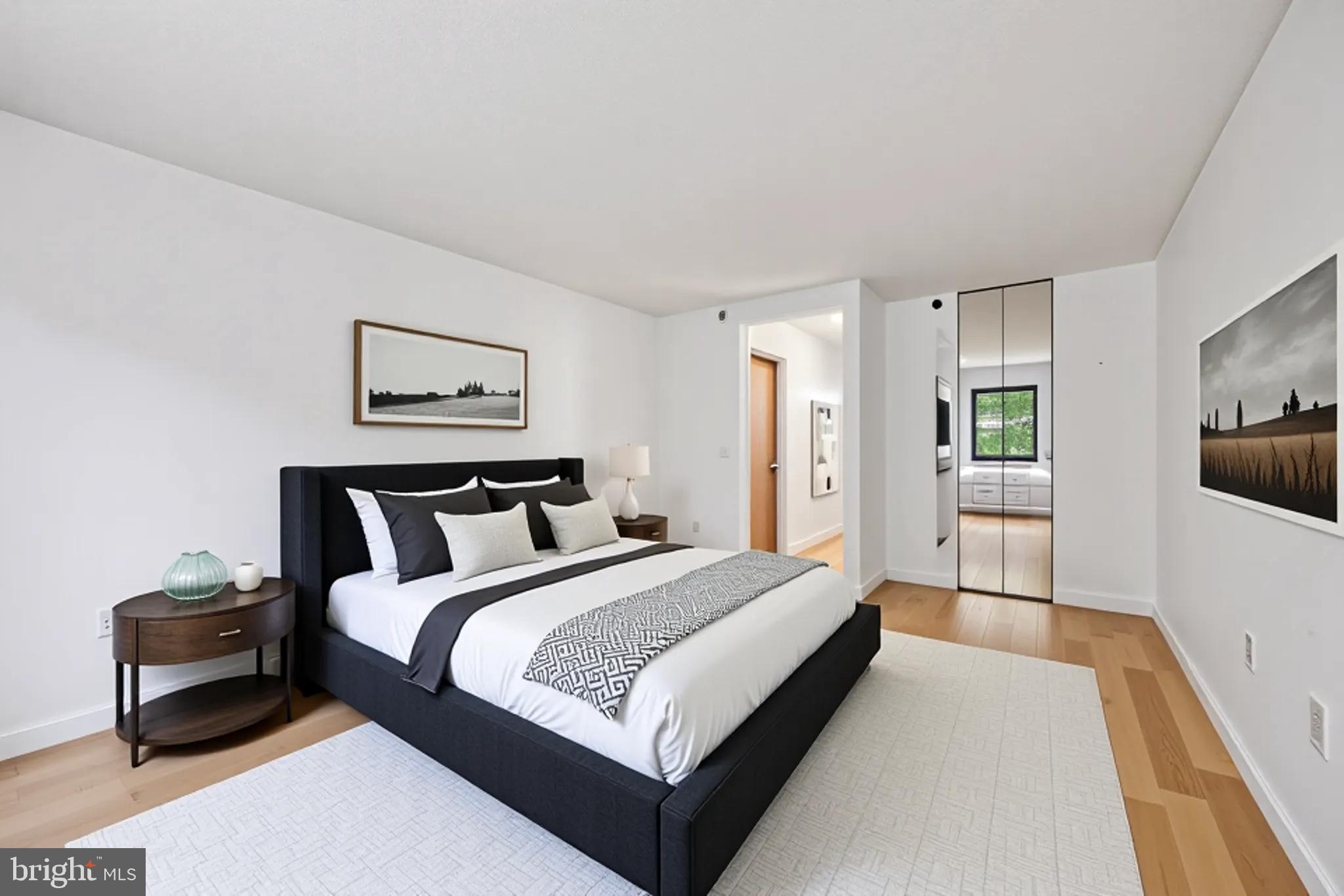 2201 Cherry Street, Unit 204 Philadelphia, PA 19103 - Photo 14 of 18 a bedroom with bed and a night stand