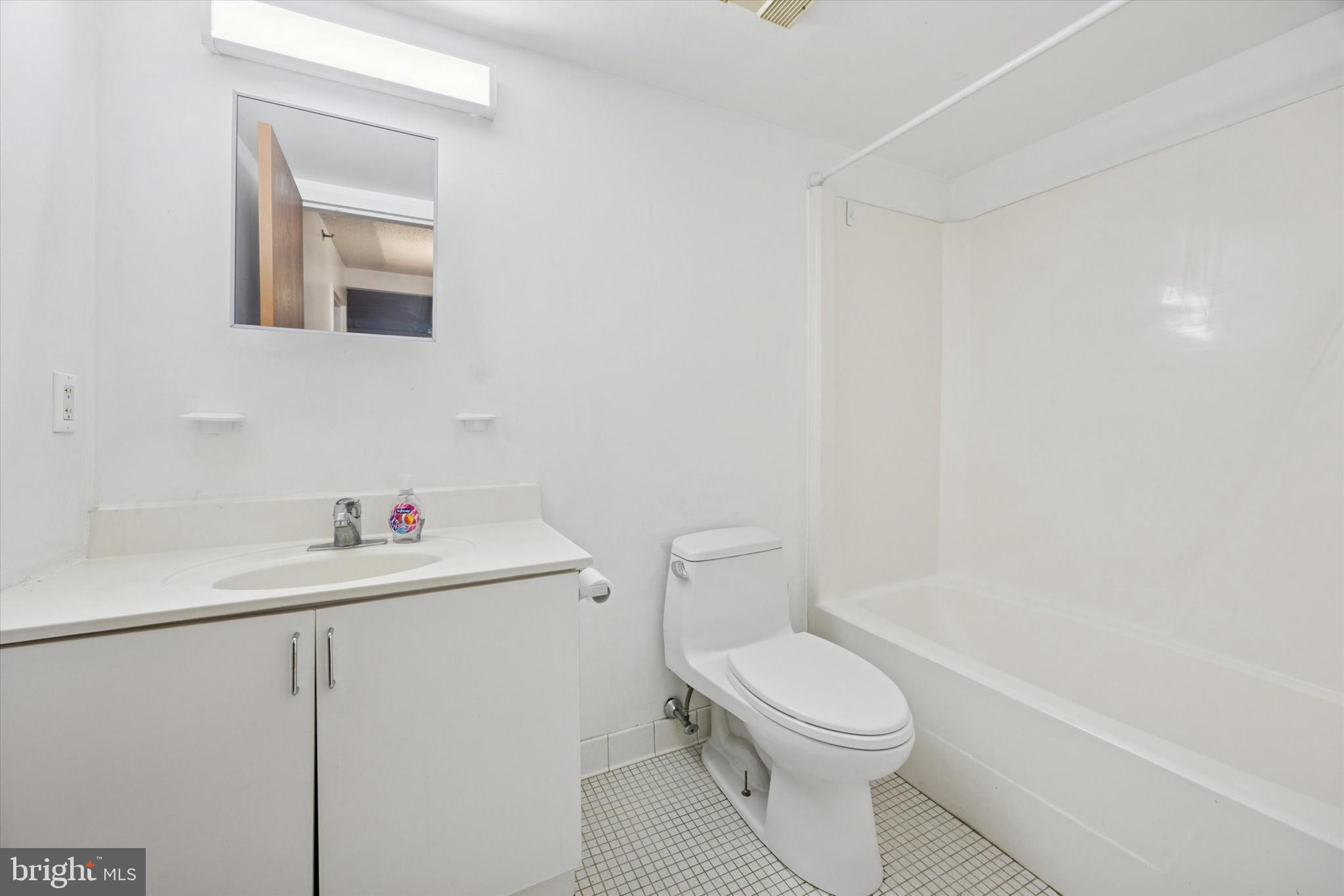 2201 Cherry Street, Unit 204 Philadelphia, PA 19103 - Photo 17 of 18 a bathroom with a toilet a sink and a mirror