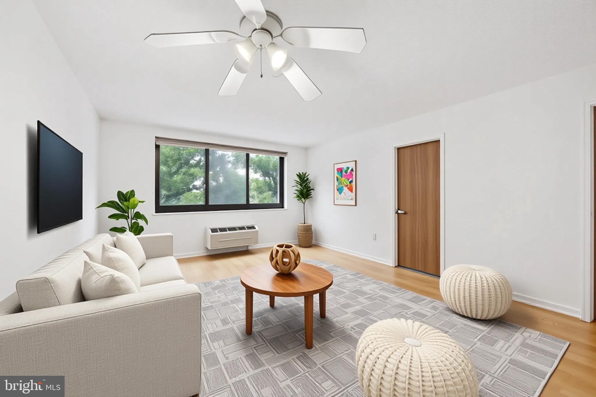 2201 Cherry Street, Unit 204 Philadelphia, PA 19103 - Photo 2 of 18 a living room with furniture and a large window