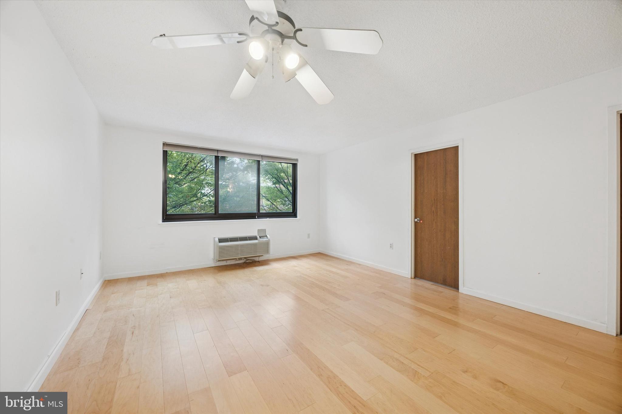 2201 Cherry Street, Unit 204 Philadelphia, PA 19103 - Photo 3 of 18 an empty room with windows and ceiling fan