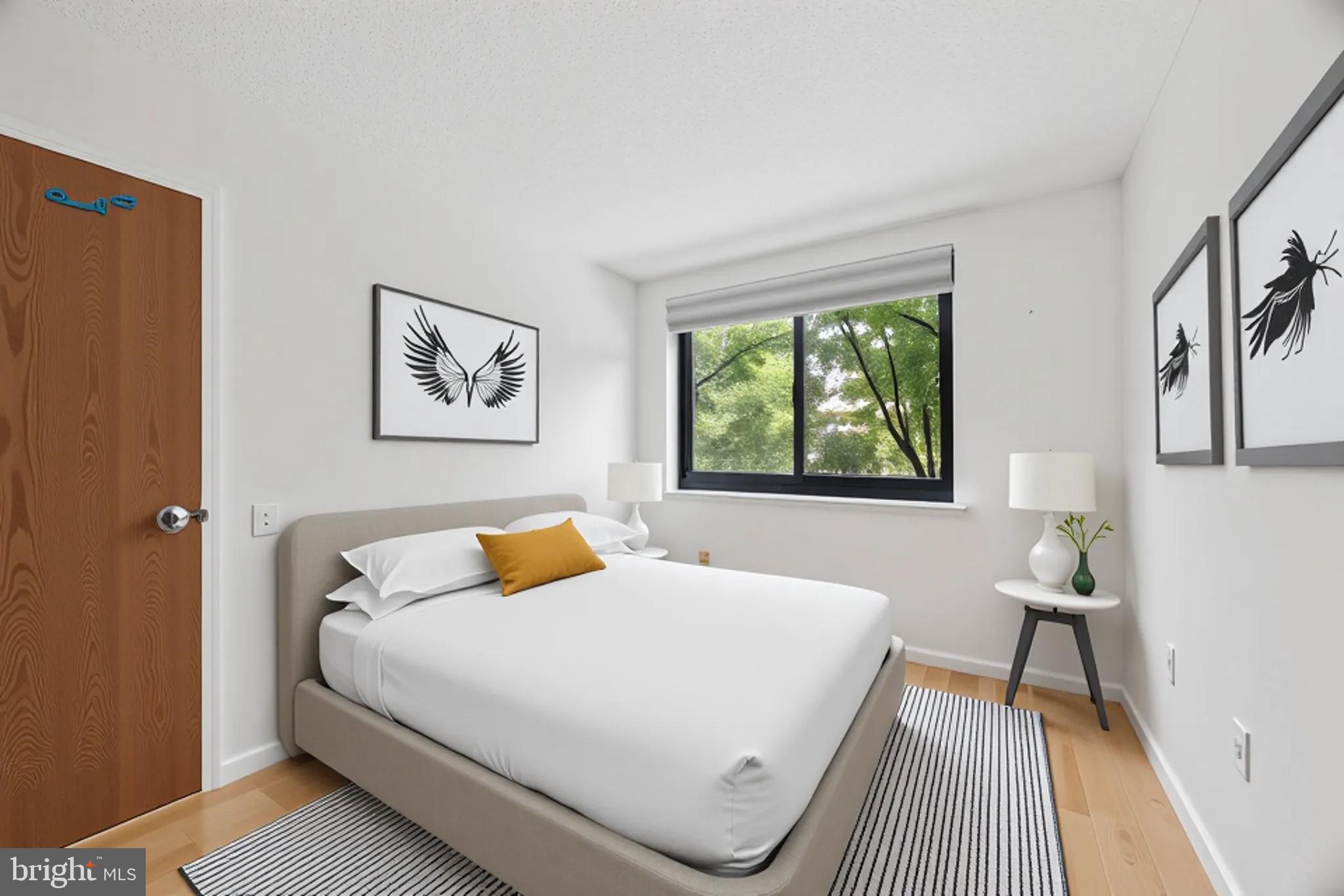 2201 Cherry Street, Unit 204 Philadelphia, PA 19103 - Photo 9 of 18 a bedroom with a bed and a window