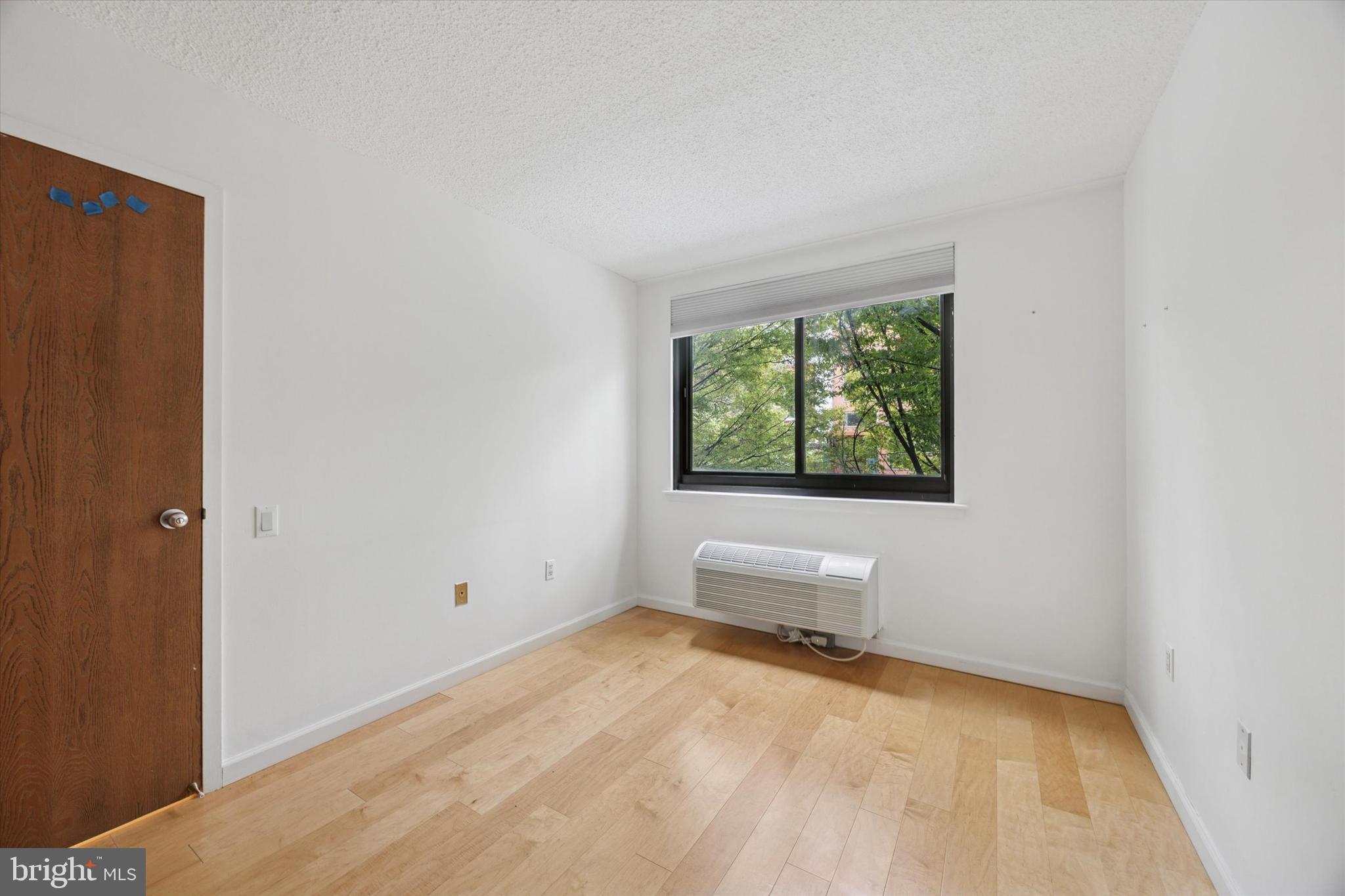 2201 Cherry Street, Unit 204 Philadelphia, PA 19103 - Photo 10 of 18 a view of empty room with wooden floor and fan