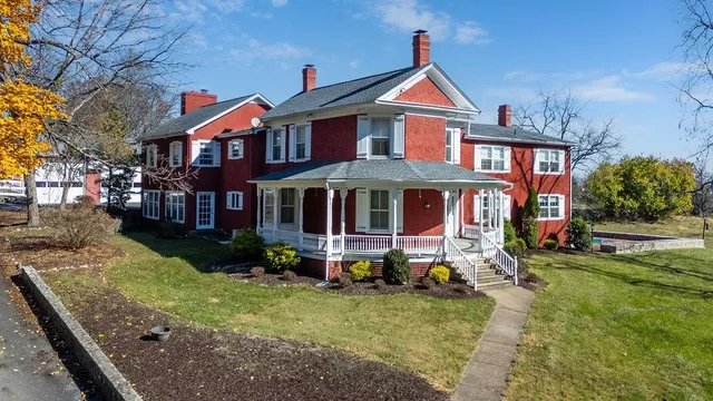 a front view of a residential apartment building with a yard