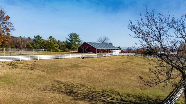 a view of a house with a yard and trees