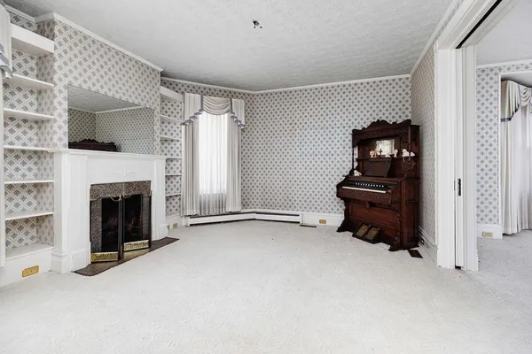 a living room with furniture a fireplace and windows