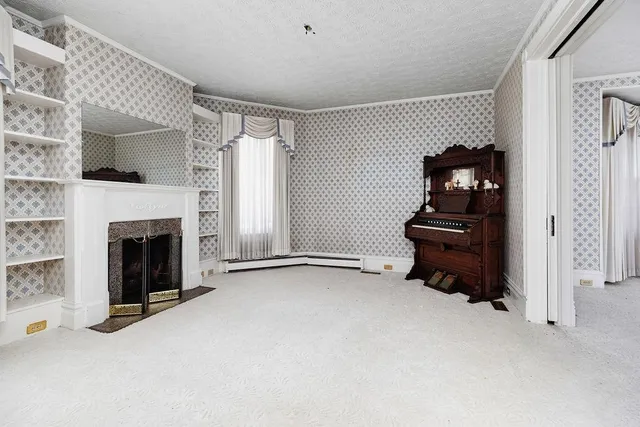 a living room with furniture a fireplace and windows
