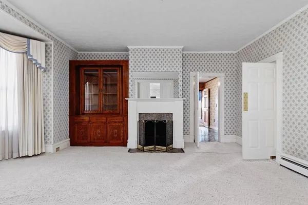 an empty room with furniture and a fireplace