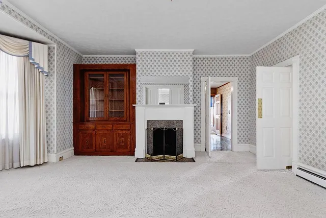 an empty room with furniture and a fireplace