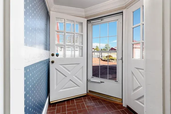 a view of an empty room with a cabinet and a window