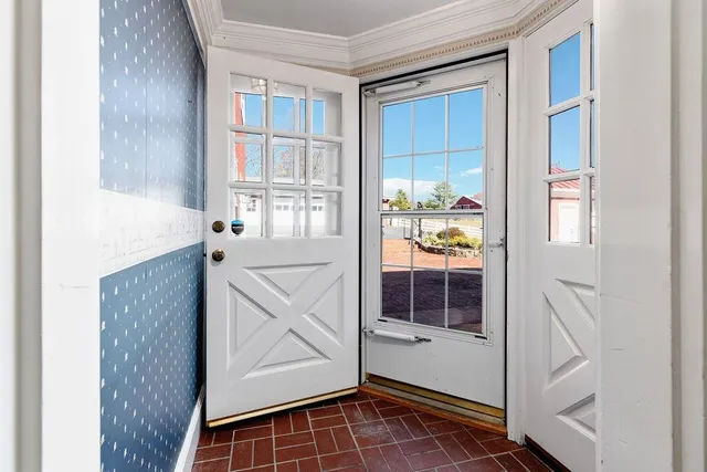 a view of an empty room with a cabinet and a window