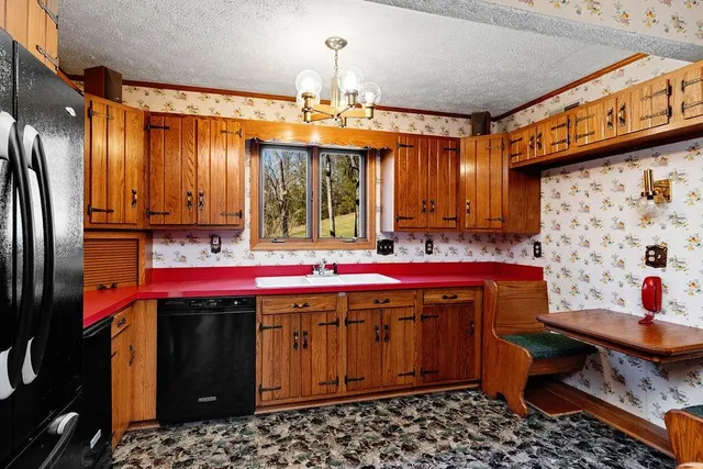 an empty room with windows and fireplace