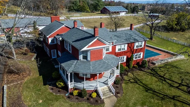 an aerial view of a house with swimming pool and garden