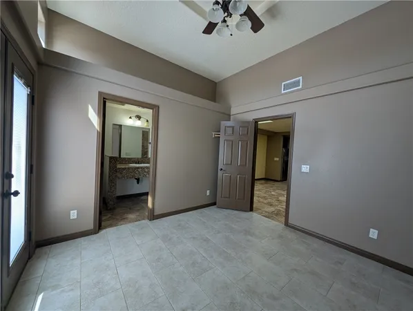 a view of an empty room and a bathroom