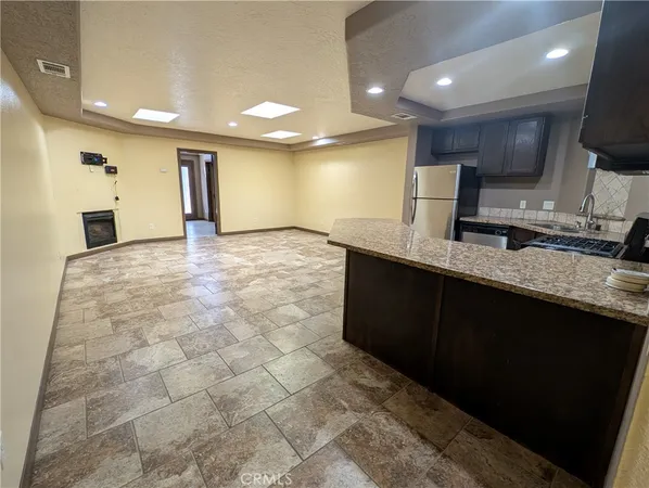 a large bathroom with a granite countertop sink a toilet a mirror and vanity