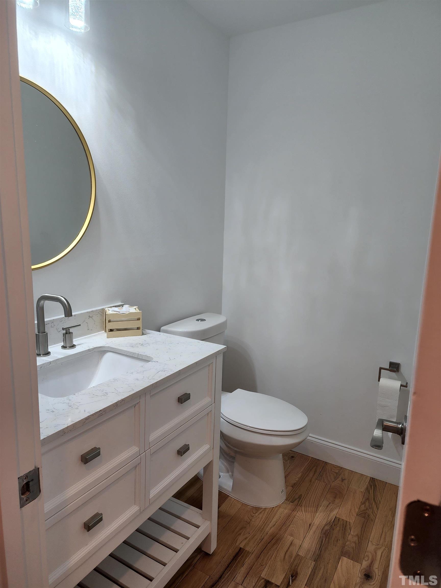 4200 Pickwick Drive Raleigh, NC 27613 - Photo 17 of 36 a bathroom with a granite countertop toilet sink and mirror