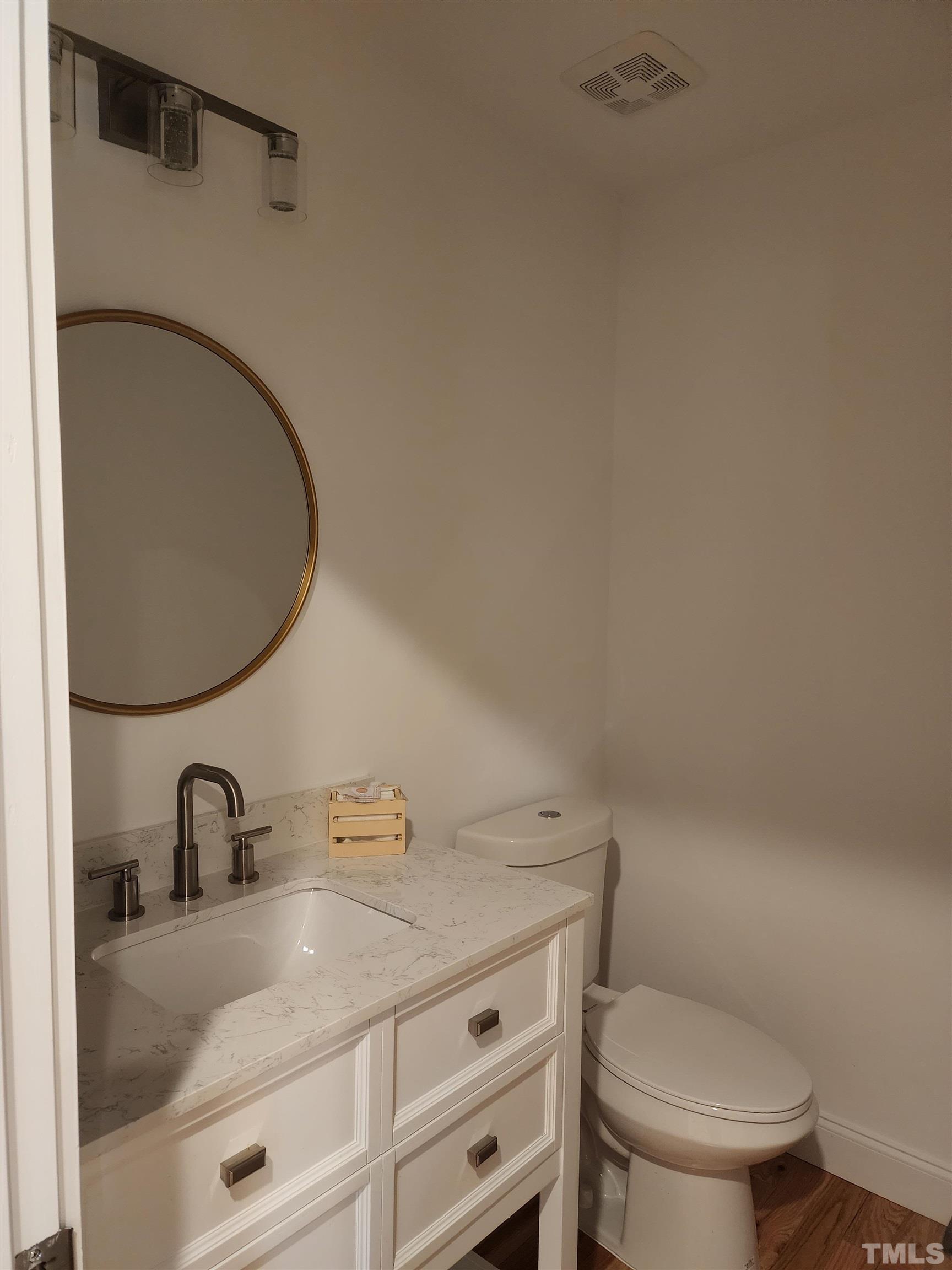 4200 Pickwick Drive Raleigh, NC 27613 - Photo 18 of 36 a bathroom with a granite countertop sink toilet and a mirror