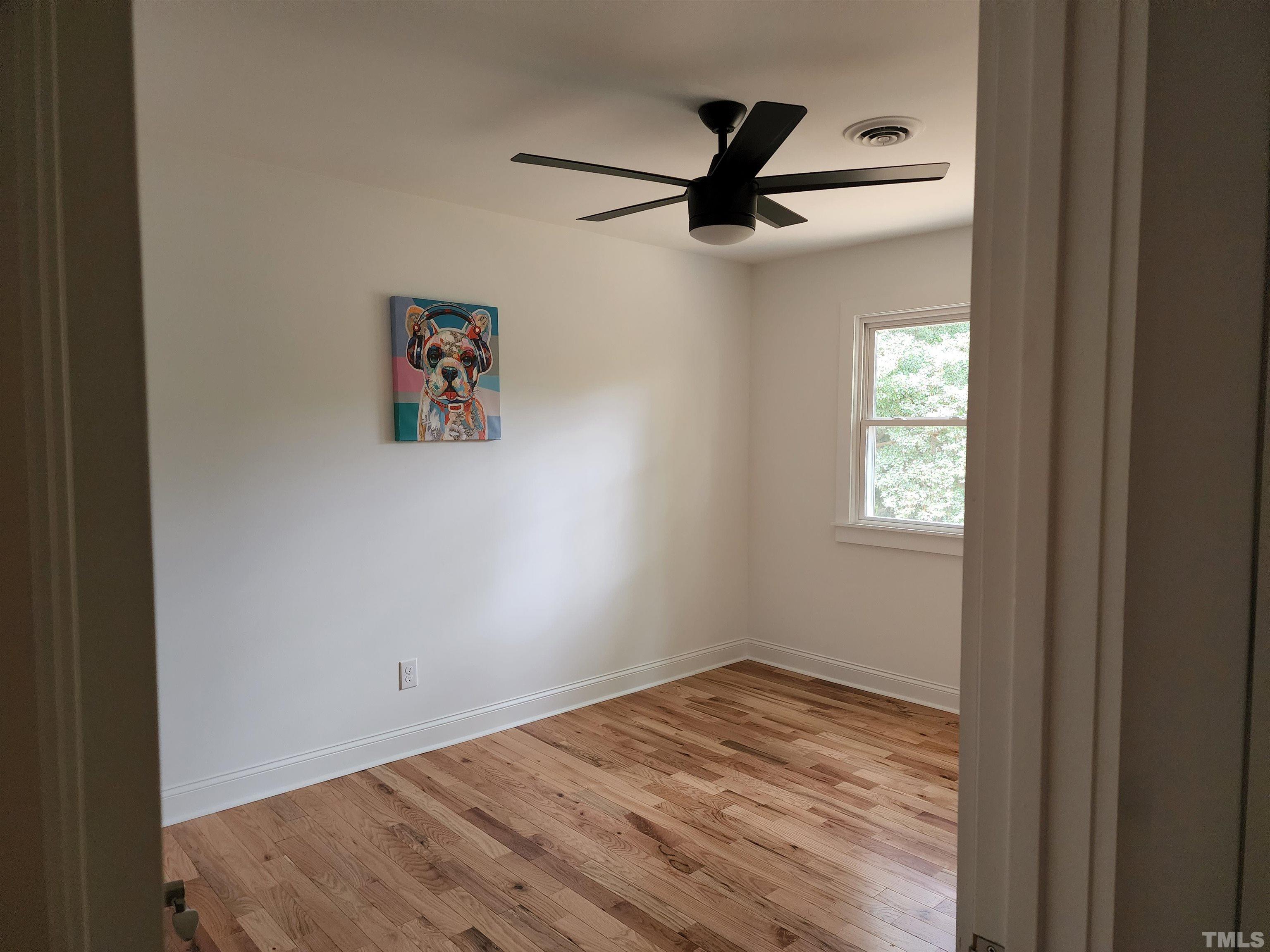 4200 Pickwick Drive Raleigh, NC 27613 - Photo 27 of 36 a view of empty room with wooden floor and window
