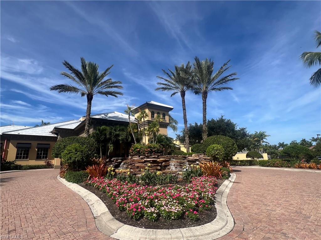 6574 Amarone Lane Naples, FL 34113 - Photo 40 of 44 a view of a house with a yard and potted plants