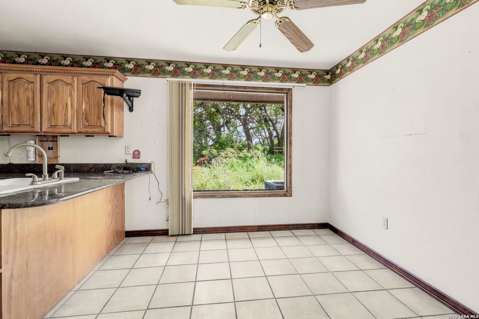 3061 Horse Ranch Road San Antonio, TX 78264 - Photo 12 of 34 a view of a kitchen with a sink and dishwasher with wooden floor