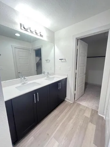 an empty room with a ceiling fan and carpet