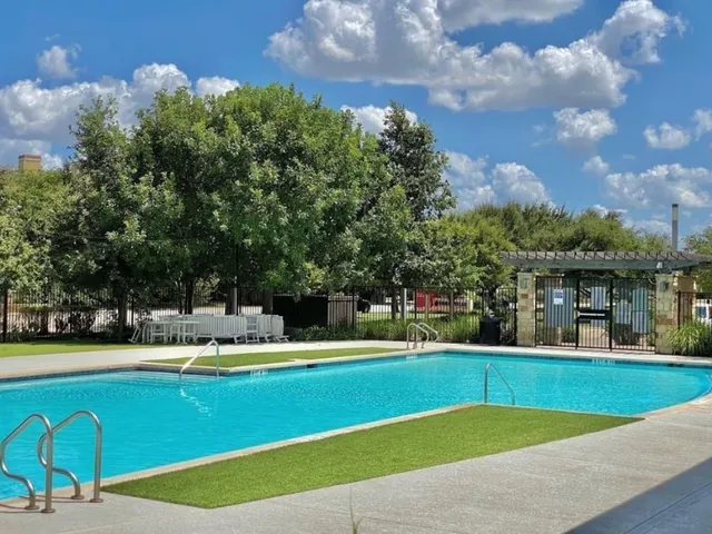 a view of a swimming pool with a yard