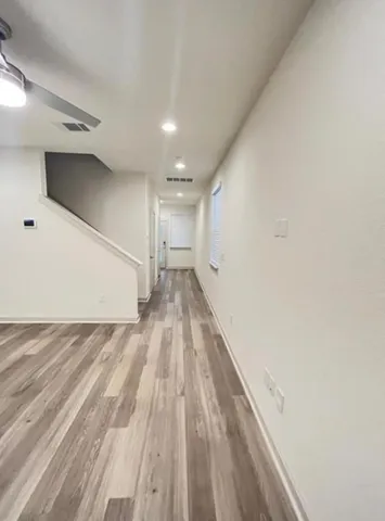 a view of kitchen with wooden floor and electronic appliances