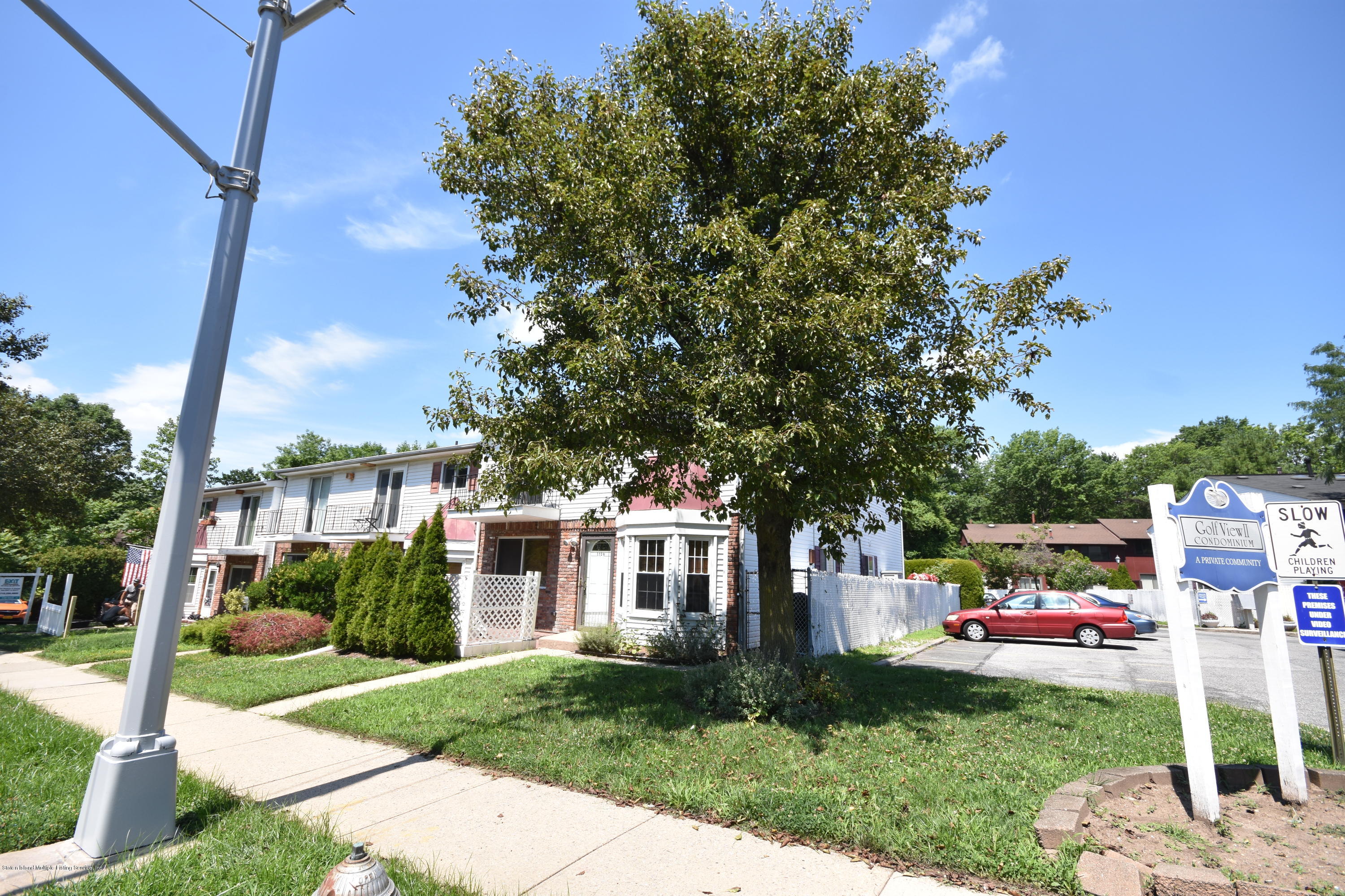 1726 Forest Hill Road Staten Island, NY 10314 - Photo 11 of 12 a front view of a house with a garden