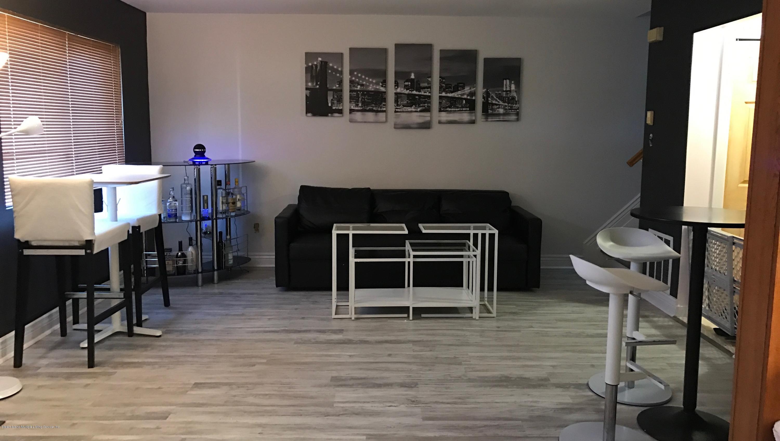 1726 Forest Hill Road Staten Island, NY 10314 - Photo 2 of 12 a living room with wooden floor and furniture