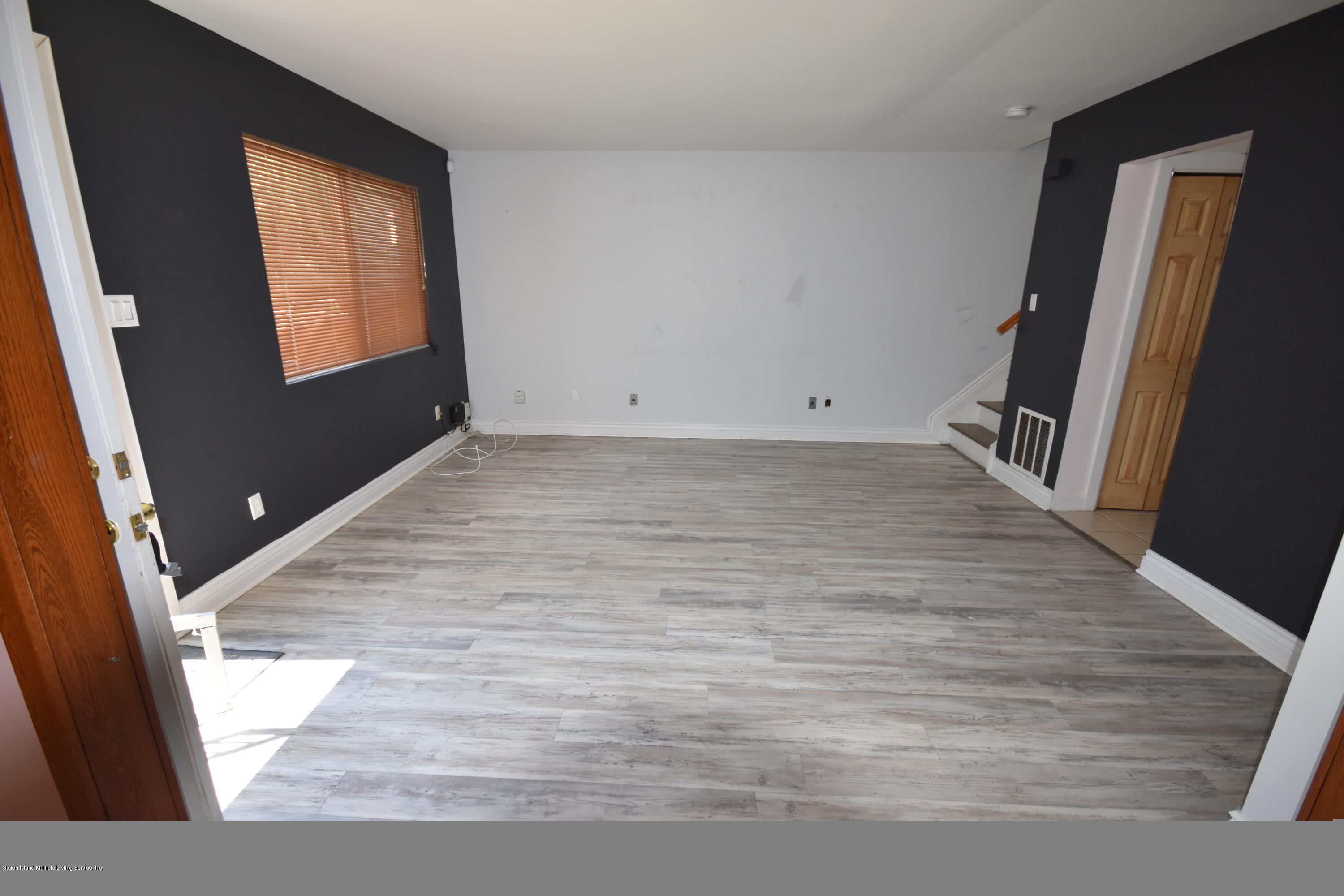 1726 Forest Hill Road Staten Island, NY 10314 - Photo 3 of 12 a view of a hallway view with wooden floor and staircase