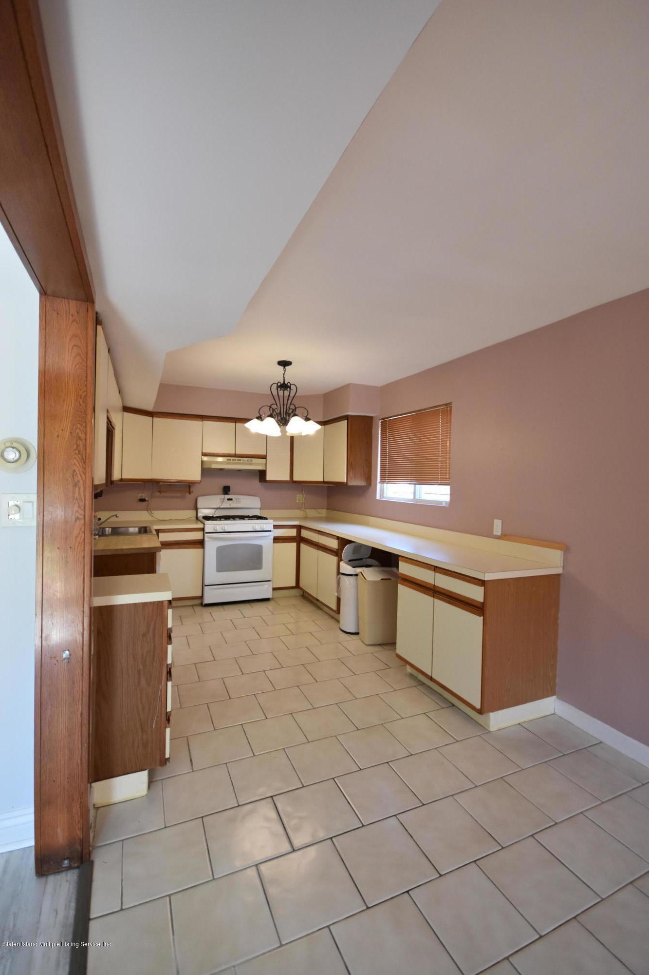 1726 Forest Hill Road Staten Island, NY 10314 - Photo 4 of 12 a kitchen with stainless steel appliances cabinets and front door