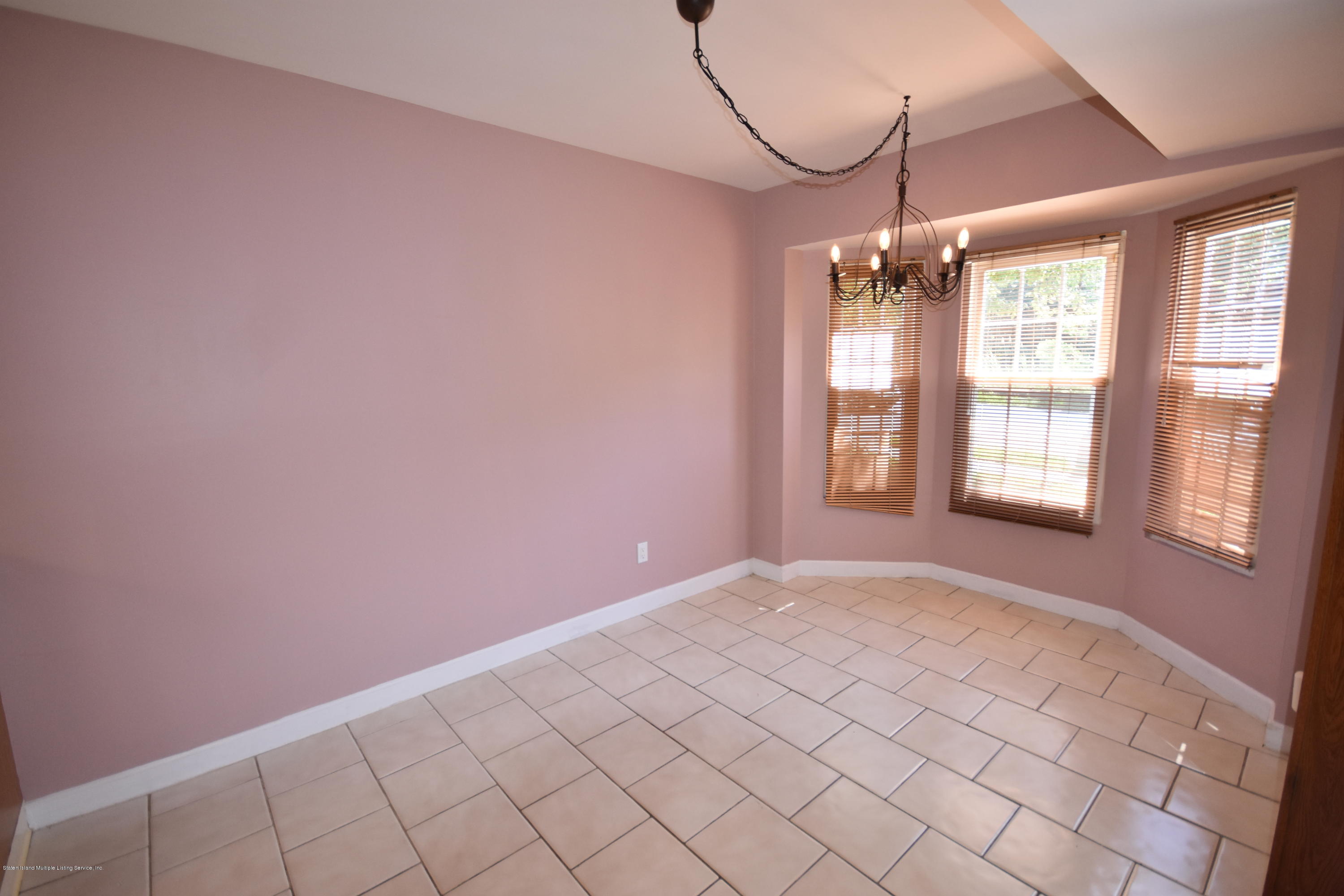1726 Forest Hill Road Staten Island, NY 10314 - Photo 5 of 12 a view of an empty room with a window
