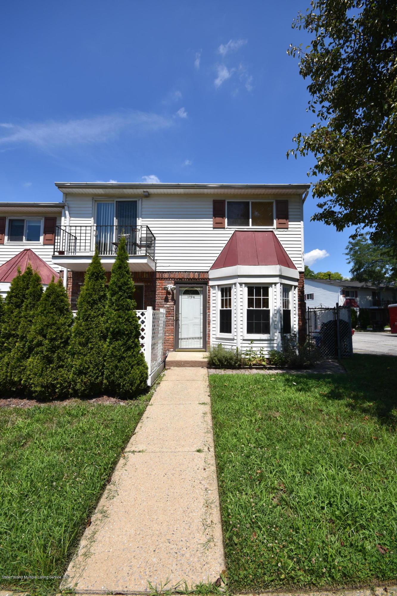 1726 Forest Hill Road Staten Island, NY 10314 - Photo 10 of 12 a front view of a house with garden
