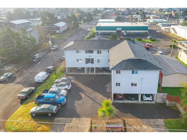 an aerial view of a house with a yard basket ball court and outdoor seating