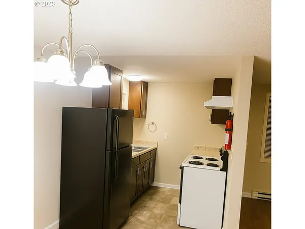 a kitchen with a sink cabinets and a window