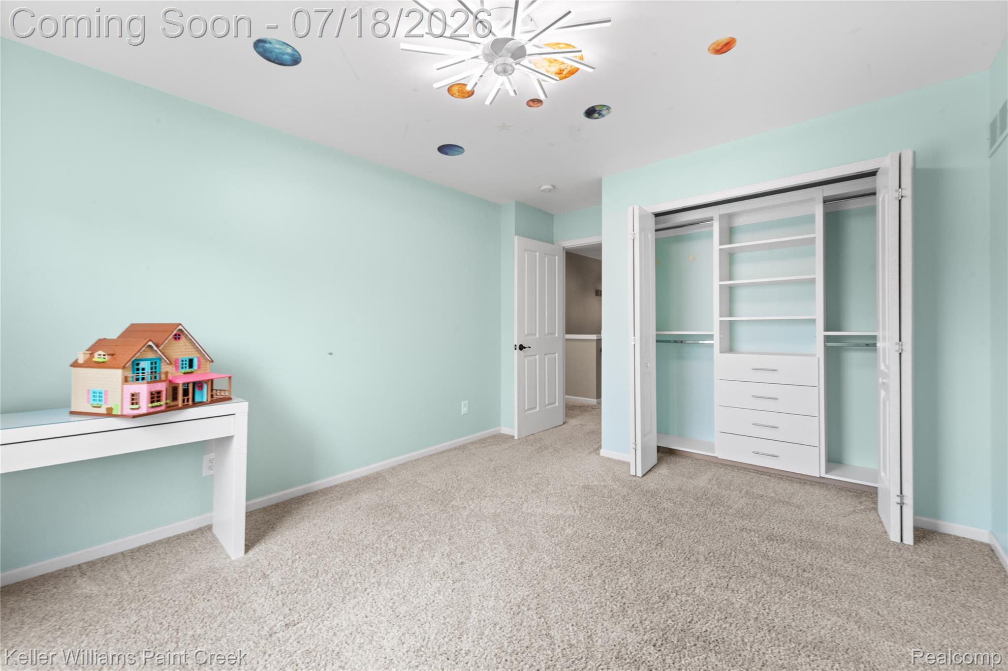 4230 Holly Lane Rochester, MI 48306 - Photo 38 of 64 Carpeted room featuring a built-in closet organization system with shelving and drawers, a flush-mount ceiling light fixture, and a solid core door