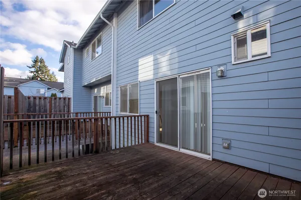 a view of backyard with a deck and wooden floor