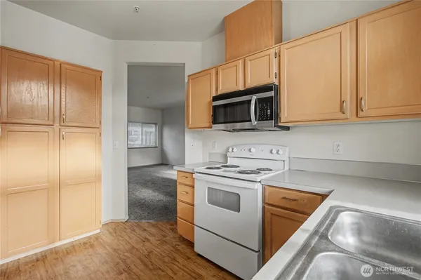 a kitchen with a refrigerator stove and microwave