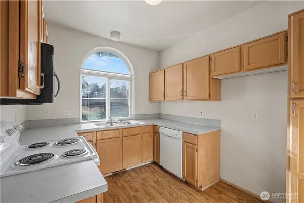 a kitchen with a sink stove and cabinets