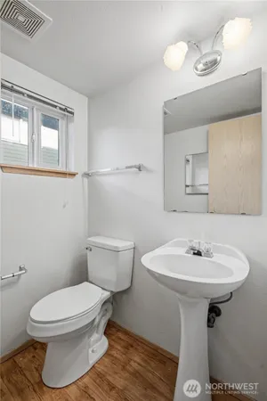 a bathroom with a sink toilet and mirror