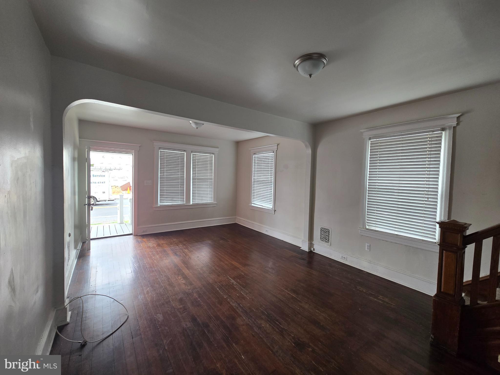 106 Main Street Mantua, NJ 08051 - Photo 4 of 23 an empty room with wooden floor and windows