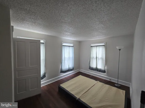 an empty room with wooden floor