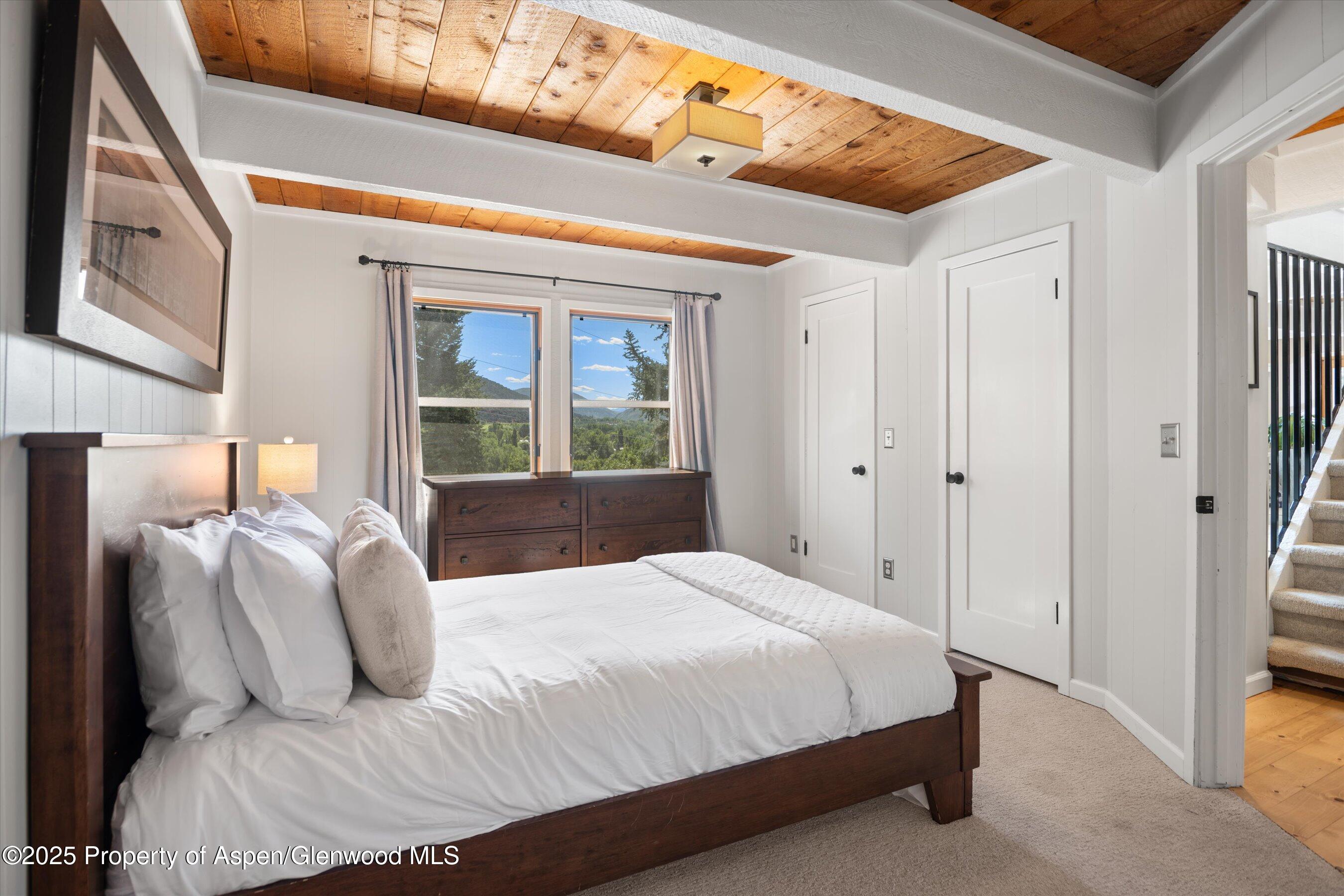217 Longhorn Lane Basalt, CO 81621 - Photo 11 of 23 a bedroom with a large bed and a window