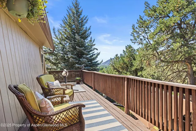 a view of balcony with wooden floor and outdoor seating