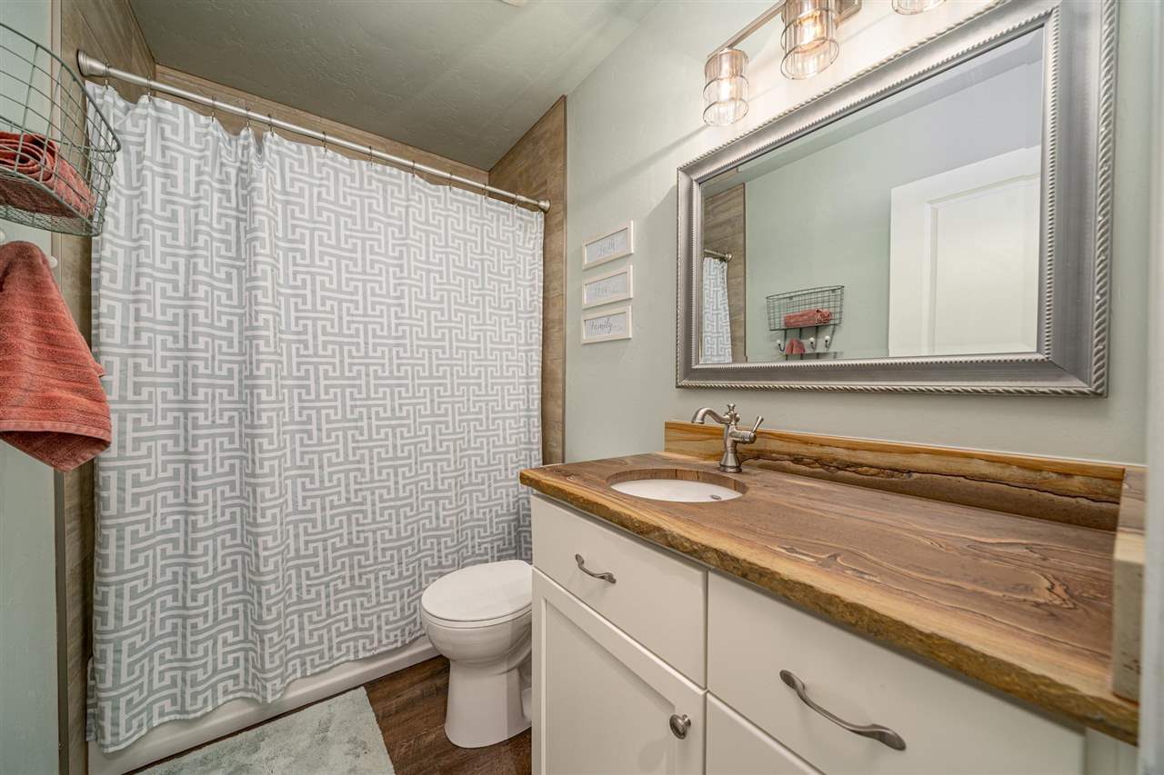 2330 E Road, Unit A & B Grand Junction, CO 81507 - Photo 34 of 35 a bathroom with a granite countertop sink toilet and shower