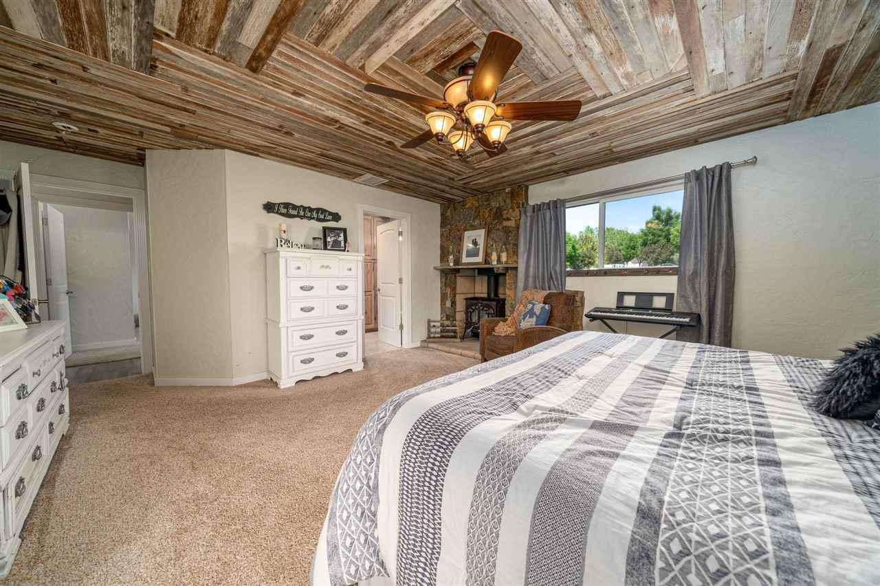 2330 E Road, Unit A & B Grand Junction, CO 81507 - Photo 8 of 35 a spacious bedroom with a bed and a dresser