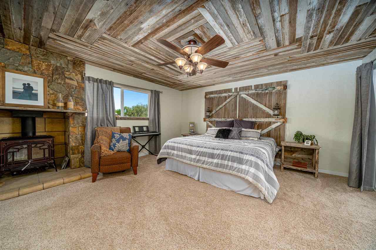 2330 E Road, Unit A & B Grand Junction, CO 81507 - Photo 9 of 35 a bedroom with a bed couch and a ceiling fan